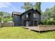 Back exterior of a house with dark siding and a well-maintained lawn and a wood deck at 2824 Tupelo Se St, Atlanta, GA 30317