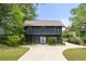 Modern two-story home with dark siding, large windows, well-manicured lawn and concrete driveway at 2824 Tupelo Se St, Atlanta, GA 30317