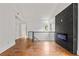 Bright hallway features hardwood floors, modern fireplace, and a staircase with black metal railings at 2824 Tupelo Se St, Atlanta, GA 30317
