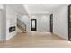 Bright living room with modern fireplace, staircase and light wood-look floors with black accents at 2824 Tupelo Se St, Atlanta, GA 30317