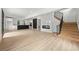Spacious living area with modern fireplace, staircase, and kitchen with light wood-look floors at 2824 Tupelo Se St, Atlanta, GA 30317