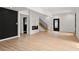 Bright, open living room featuring modern fireplace, staircase and light wood-look floors at 2824 Tupelo Se St, Atlanta, GA 30317