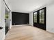 Living room with black accent wall, barn door, and French doors for a sleek aesthetic at 2824 Tupelo Se St, Atlanta, GA 30317
