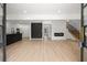 Open-concept living room with modern fireplace, staircase, black kitchen and wood-look floors at 2824 Tupelo Se St, Atlanta, GA 30317
