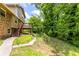 A wooden deck with steps enhance backyard view, complemented by a charming pathway leading to the lush garden at 440 Ohern Ct, Stone Mountain, GA 30088