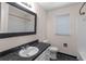 Bathroom features a dark granite vanity top, white cabinets, toilet, and a shower-tub combo at 440 Ohern Ct, Stone Mountain, GA 30088