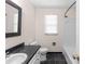 Bathroom with a black countertop vanity, toilet, window, and shower-tub combo at 440 Ohern Ct, Stone Mountain, GA 30088