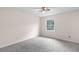 Bright bedroom with a ceiling fan, neutral walls, plush gray carpet, and a window that offers natural light at 440 Ohern Ct, Stone Mountain, GA 30088