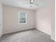 Bright carpeted bedroom with a window, creating a cozy and comfortable space at 440 Ohern Ct, Stone Mountain, GA 30088
