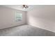 Carpeted bedroom with a window AC unit, offering a comfortable space for rest and relaxation at 440 Ohern Ct, Stone Mountain, GA 30088