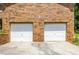 Spacious two-car garage with white doors and a brick facade for a classic and durable look at 440 Ohern Ct, Stone Mountain, GA 30088
