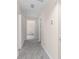 Carpeted hallway with neutral paint and multiple doorways at 440 Ohern Ct, Stone Mountain, GA 30088