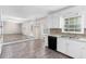 Bright eat-in kitchen boasts white cabinetry, granite countertops, and stainless steel appliances at 440 Ohern Ct, Stone Mountain, GA 30088