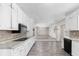 Spacious kitchen with white cabinets, granite countertops, and tile flooring at 440 Ohern Ct, Stone Mountain, GA 30088