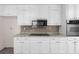 Spacious kitchen with white cabinetry and stainless steel microwave and oven at 440 Ohern Ct, Stone Mountain, GA 30088