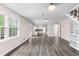 Spacious living room boasts hardwood flooring, access to kitchen, and lots of light at 440 Ohern Ct, Stone Mountain, GA 30088