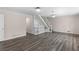 Large living room with staircase, hardwood floors, and built-in shelving at 440 Ohern Ct, Stone Mountain, GA 30088