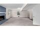 Spacious living room with a blue brick fireplace and neutral carpet at 440 Ohern Ct, Stone Mountain, GA 30088