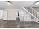 Open living room with hardwood flooring and a staircase with built-in shelves at 440 Ohern Ct, Stone Mountain, GA 30088