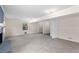 Large living room with carpeting and an adjacent room with hardwood flooring at 440 Ohern Ct, Stone Mountain, GA 30088