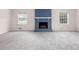 Cozy living room with a blue fireplace and light gray carpet at 440 Ohern Ct, Stone Mountain, GA 30088