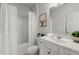 Bathroom with bathtub, toilet, and vanity featuring white cabinets and black hardware at 485 St Annes Pl, Covington, GA 30016