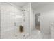 This luxurious bathroom features white subway tile, a glass enclosed shower, and marble floors at 485 St Annes Pl, Covington, GA 30016