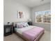 Bright bedroom featuring a queen-size bed and a large window that provides plenty of natural light at 485 St Annes Pl, Covington, GA 30016