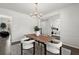 Dining room with modern lighting, white walls, and hardwood flooring at 485 St Annes Pl, Covington, GA 30016