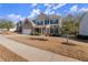 Attractive two-story home with stone and siding, complemented by a green lawn and professional landscaping at 485 St Annes Pl, Covington, GA 30016