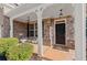 Inviting front porch with decorative stone, seating, hanging lanterns and an elegant front door at 485 St Annes Pl, Covington, GA 30016