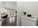 Hallway featuring hardwood floors leading into the kitchen with a decorative dresser at 485 St Annes Pl, Covington, GA 30016