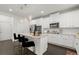 Stylish kitchen with white cabinets, stainless steel appliances, a center island, and a subway tile backsplash at 485 St Annes Pl, Covington, GA 30016