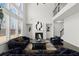 Bright living room showcasing high ceilings, large windows, a modern fireplace, and access to the staircase and upper level at 485 St Annes Pl, Covington, GA 30016
