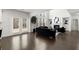 Living room area with hardwood flooring and lots of windows with natural light at 485 St Annes Pl, Covington, GA 30016