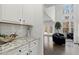 View into the living room showcasing high ceilings, large windows and comfortable seating adjacent to the kitchen and dining areas at 485 St Annes Pl, Covington, GA 30016