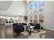 Bright and airy living room with vaulted ceilings, large windows, modern furnishings, and an open view to the kitchen at 485 St Annes Pl, Covington, GA 30016