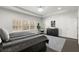 This main bedroom features dark hardwood floors, a queen sized bed, a large window, and neutral decor at 485 St Annes Pl, Covington, GA 30016