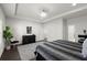 The main bedroom features dark hardwood floors, a queen sized bed, a large window, and neutral decor at 485 St Annes Pl, Covington, GA 30016