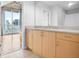 Bathroom featuring light colored cabinets and granite countertops, with a view of the city at 860 Peachtree Ne St # 909, Atlanta, GA 30308