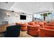 Modern conference room featuring comfortable orange chairs, a TV, and bright lighting, ideal for meetings and presentations at 860 Peachtree Ne St # 909, Atlanta, GA 30308