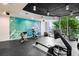 Community gym with modern equipment and a bright mural on the wall at 860 Peachtree Ne St # 909, Atlanta, GA 30308