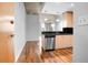 Modern kitchen featuring stainless steel appliances, light cabinets, and hardwood floors at 860 Peachtree Ne St # 909, Atlanta, GA 30308