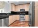 Bright kitchen features stainless steel appliances, tile backsplash, wood cabinets, and concrete ceilings at 860 Peachtree Ne St # 909, Atlanta, GA 30308
