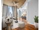Staged living room with hardwood floors, cityscape view, concrete ceilings, and bright natural light at 860 Peachtree Ne St # 909, Atlanta, GA 30308