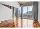 Bright living room with hardwood floors, large windows, and city views at 860 Peachtree Ne St # 909, Atlanta, GA 30308