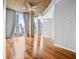 Sunlit living room with hardwood floors, large windows, and a concrete ceiling at 860 Peachtree Ne St # 909, Atlanta, GA 30308