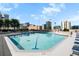 Rooftop swimming pool surrounded by city skyline and trees, with chairs for relaxing at 860 Peachtree Ne St # 909, Atlanta, GA 30308
