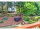 Private backyard with lush landscaping, mature trees, and a mulched area at 3125 Flatbottom Dr, Dacula, GA 30019