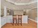 Finished basement bar featuring white wainscoting and a stainless steel refrigerator at 3125 Flatbottom Dr, Dacula, GA 30019